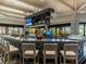 Upscale bar area with comfortable seating, multiple TVs, and well-stocked liquor display at 5694 Palmer Cir # 202, Bradenton, FL 34211