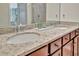 Close-up of a bathroom vanity with granite countertops, double sinks, and elegant fixtures at 5694 Palmer Cir # 202, Bradenton, FL 34211