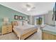 Bright bedroom with a large window, light wood furniture, and a decorative accent wall for a serene atmosphere at 5694 Palmer Cir # 202, Bradenton, FL 34211
