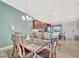 Open dining area with wood table, pendant lighting, and adjacent kitchen featuring modern appliances at 5694 Palmer Cir # 202, Bradenton, FL 34211