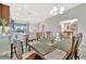 Open-concept dining area with a wooden table, with a view of the living area and kitchen at 5694 Palmer Cir # 202, Bradenton, FL 34211