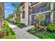 Exterior angle view of the building with a nice brick walkway and tropical greenery at 5694 Palmer Cir # 202, Bradenton, FL 34211