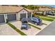 Charming exterior view of home featuring grey driveway and a golf cart at 5694 Palmer Cir # 202, Bradenton, FL 34211