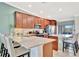 Kitchen boasts granite counters, stainless appliances, and island seating, perfect for casual dining at 5694 Palmer Cir # 202, Bradenton, FL 34211