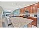 Modern kitchen features a large island, granite countertops, and stainless steel appliances at 5694 Palmer Cir # 202, Bradenton, FL 34211