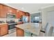 Kitchen boasts stainless appliances, granite countertops, and easy access to the outdoor patio at 5694 Palmer Cir # 202, Bradenton, FL 34211