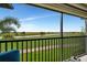 Relaxing screened lanai showcasing a serene view of the golf course and lake at 5694 Palmer Cir # 202, Bradenton, FL 34211
