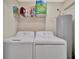 Efficient laundry area with a washer, dryer, and storage shelf to keep things organized at 5694 Palmer Cir # 202, Bradenton, FL 34211