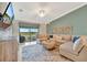 Comfortable living room with a large sectional sofa, golf course views, and a ceiling fan at 5694 Palmer Cir # 202, Bradenton, FL 34211