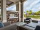Cozy outdoor patio area with comfortable seating, a stone accent wall and a modern fireplace at 5694 Palmer Cir # 202, Bradenton, FL 34211