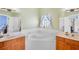 Bathroom with a large soaking tub and and sinks at 6311 Sturbridge Ct, Sarasota, FL 34238