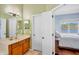 Ensuite bathroom features a double sink vanity with wood cabinets at 6311 Sturbridge Ct, Sarasota, FL 34238