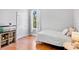 Cozy bedroom with hardwood floors, large window, and shelving unit at 6311 Sturbridge Ct, Sarasota, FL 34238