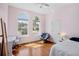 Sunny bedroom with hardwood floors and arched windows at 6311 Sturbridge Ct, Sarasota, FL 34238