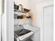 Bright laundry room features a modern washer and dryer with convenient overhead shelving at 6311 Sturbridge Ct, Sarasota, FL 34238