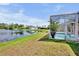 Outdoor screened-in pool overlooks the lake and lush greenery at 6311 Sturbridge Ct, Sarasota, FL 34238