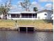 A quaint property featuring a waterfront backyard and private dock for boating activities at 6339 Pontiac Ln, North Port, FL 34287
