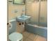 Classic bathroom featuring a blue sink, toilet, and a shower/tub combo at 6339 Pontiac Ln, North Port, FL 34287