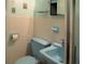 Cozy bathroom features a blue toilet, sink, and matching tile accents at 6339 Pontiac Ln, North Port, FL 34287