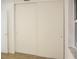 Bedroom featuring a closet with two sliding doors and a small window at 6339 Pontiac Ln, North Port, FL 34287