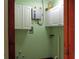 Laundry room offers white cabinets and utility sink at 6339 Pontiac Ln, North Port, FL 34287