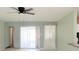 Spacious living room with sliding doors to a patio and a ceiling fan at 6339 Pontiac Ln, North Port, FL 34287