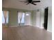 Open living room with tile floor, neutral color palette and natural light from front windows at 6339 Pontiac Ln, North Port, FL 34287