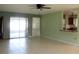 Bright living room featuring tile flooring, access to the kitchen, and sliding glass doors at 6339 Pontiac Ln, North Port, FL 34287
