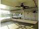 Spacious screened-in patio area with fan, overlooking backyard and waterway at 6339 Pontiac Ln, North Port, FL 34287