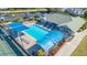 Aerial view showcases the community pool, clubhouse and tennis courts for the residents to enjoy at 6501 Stone River Rd # 304, Bradenton, FL 34203