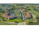 An aerial view of the property's well-maintained landscaping and proximity to a lush green golf course at 6501 Stone River Rd # 304, Bradenton, FL 34203