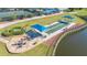 Aerial view showcases the community amenities; bocce ball court, tennis courts, pool and clubhouse at 6501 Stone River Rd # 304, Bradenton, FL 34203