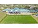 Aerial view of the golf course driving range, putting green, clubhouse, parking lot and tennis courts on a sunny day at 6501 Stone River Rd # 304, Bradenton, FL 34203