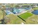 Aerial view of a golf course featuring a clubhouse, driving range, putting green, ponds, and residential area at 6501 Stone River Rd # 304, Bradenton, FL 34203