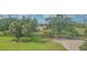 Expansive backyard featuring lush green grass, mature trees, and well-manicured landscaping at 6501 Stone River Rd # 304, Bradenton, FL 34203