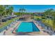 The community pool offers lounge chairs and a covered outdoor dining area at 6501 Stone River Rd # 304, Bradenton, FL 34203