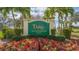 Tara Golf & Country Club's sign is surrounded by well-maintained shrubs and colorful flowers, with palm trees adding to the landscape at 6501 Stone River Rd # 304, Bradenton, FL 34203