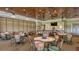Dining area featuring carpeted floors, well-lit tables and chairs with ceiling fans overhead at 6501 Stone River Rd # 304, Bradenton, FL 34203