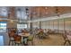Spacious dining area with carpeted floors, well-lit tables and chairs with ceiling fans throughout at 6501 Stone River Rd # 304, Bradenton, FL 34203
