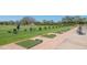 Picture of the driving range on the golf course with lush green grass and brick pavers leading to each station at 6501 Stone River Rd # 304, Bradenton, FL 34203