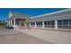 A clubhouse exterior with large windows, white columns, a well-maintained entrance, and golf carts parked nearby at 6501 Stone River Rd # 304, Bradenton, FL 34203