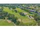 Picturesque aerial showcasing the lush golf course surrounded by mature trees and landscaping at 6501 Stone River Rd # 304, Bradenton, FL 34203