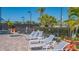 Community hot tub surrounded by mature landscaping and lounge chairs at 6501 Stone River Rd # 304, Bradenton, FL 34203