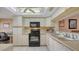 Functional kitchen with white cabinetry and modern appliances, plus an adjacent office space at 6501 Stone River Rd # 304, Bradenton, FL 34203