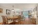 Bright living room featuring hardwood floors, dining area, and sliding glass doors to the sun room at 6501 Stone River Rd # 304, Bradenton, FL 34203