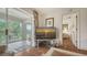 Living room featuring balcony access, hard wood floors, and a flat screen TV at 6501 Stone River Rd # 304, Bradenton, FL 34203