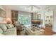 Comfortable living room with floral curtains, leather recliner, and balcony access at 6501 Stone River Rd # 304, Bradenton, FL 34203