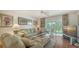 Bright and airy living area with comfortable seating, TV, and sliding glass doors to the lanai at 6501 Stone River Rd # 304, Bradenton, FL 34203