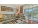 Cozy living room with comfortable seating and access to a bright sunroom with floor-to-ceiling windows at 6501 Stone River Rd # 304, Bradenton, FL 34203