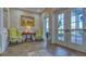 Welcoming lobby area with tiled floors, a painting, comfortable seating and an abundance of natural light at 6501 Stone River Rd # 304, Bradenton, FL 34203